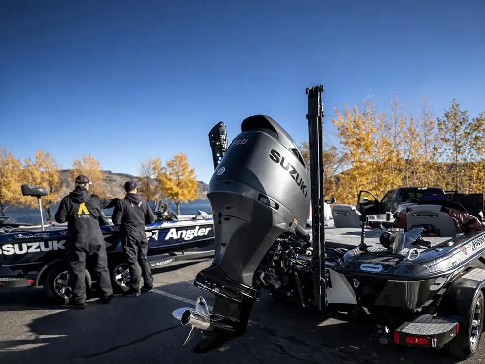Bass boats with Suzuki outboards prepared for service and rigging