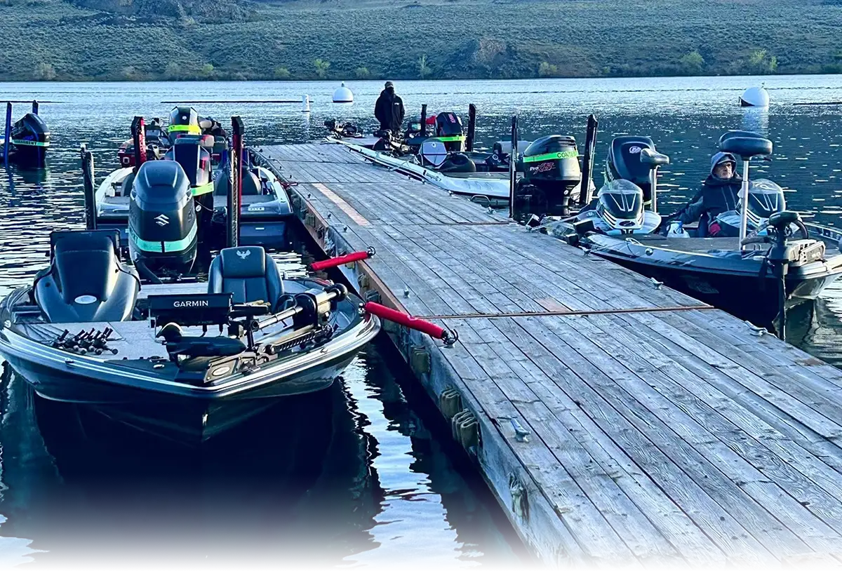 Bass boats lined up at the dock with anglers preparing for a day on the water